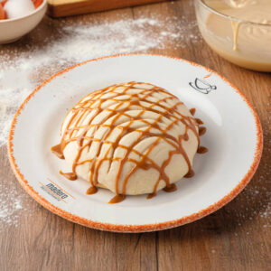 Concha bañada con dulce de leche